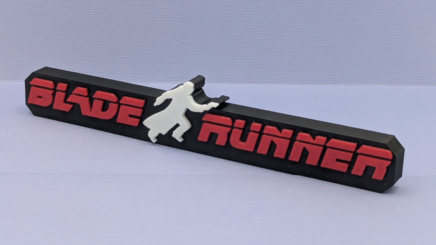Blade runner logo with a running man silhouette, on a black background.