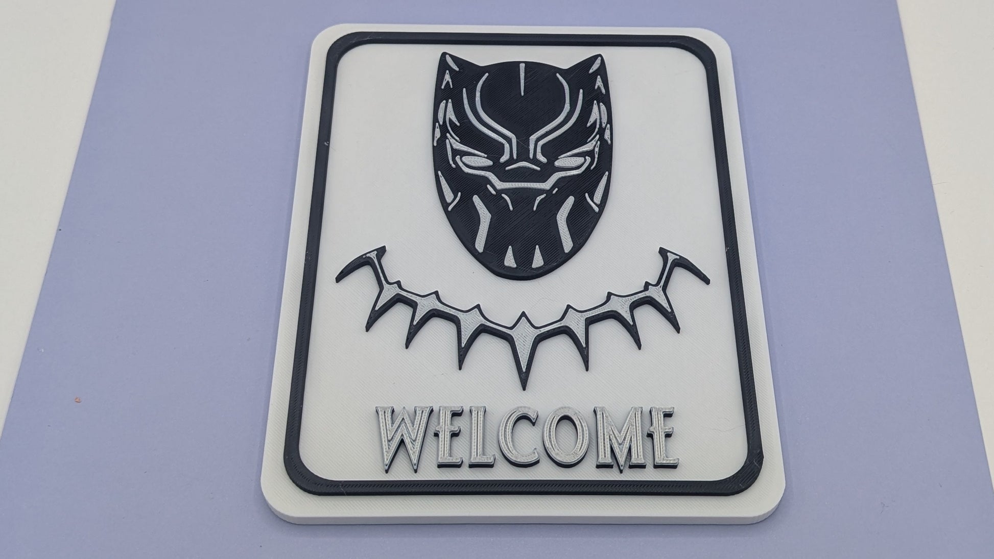 Black Panther welcome sign on a purple mat