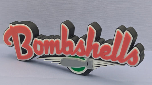 3D logo with 'Bombshells' text on a gray background