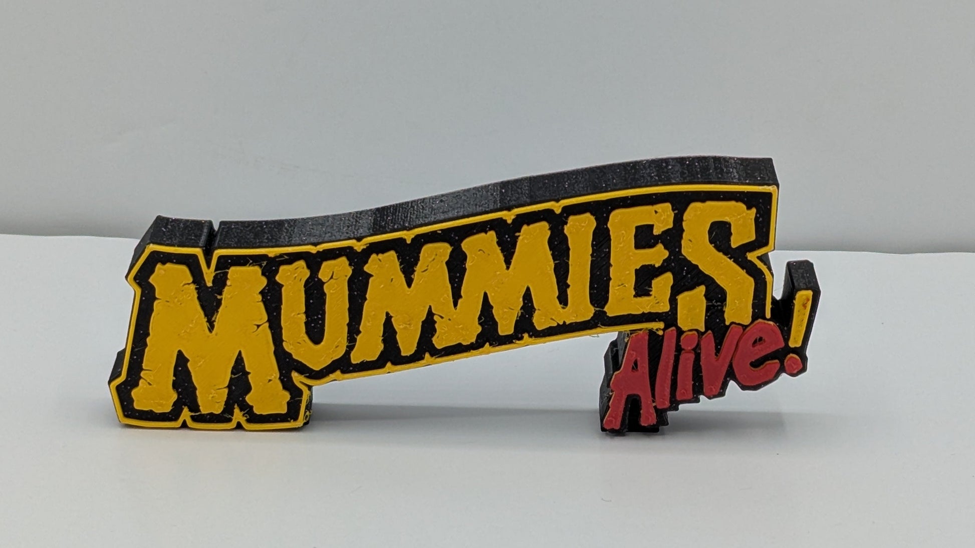 mummies alive logo in gold and red lettering