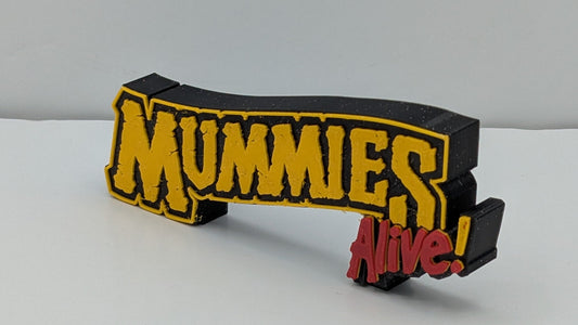 Mummies alive in gold and red lettering
