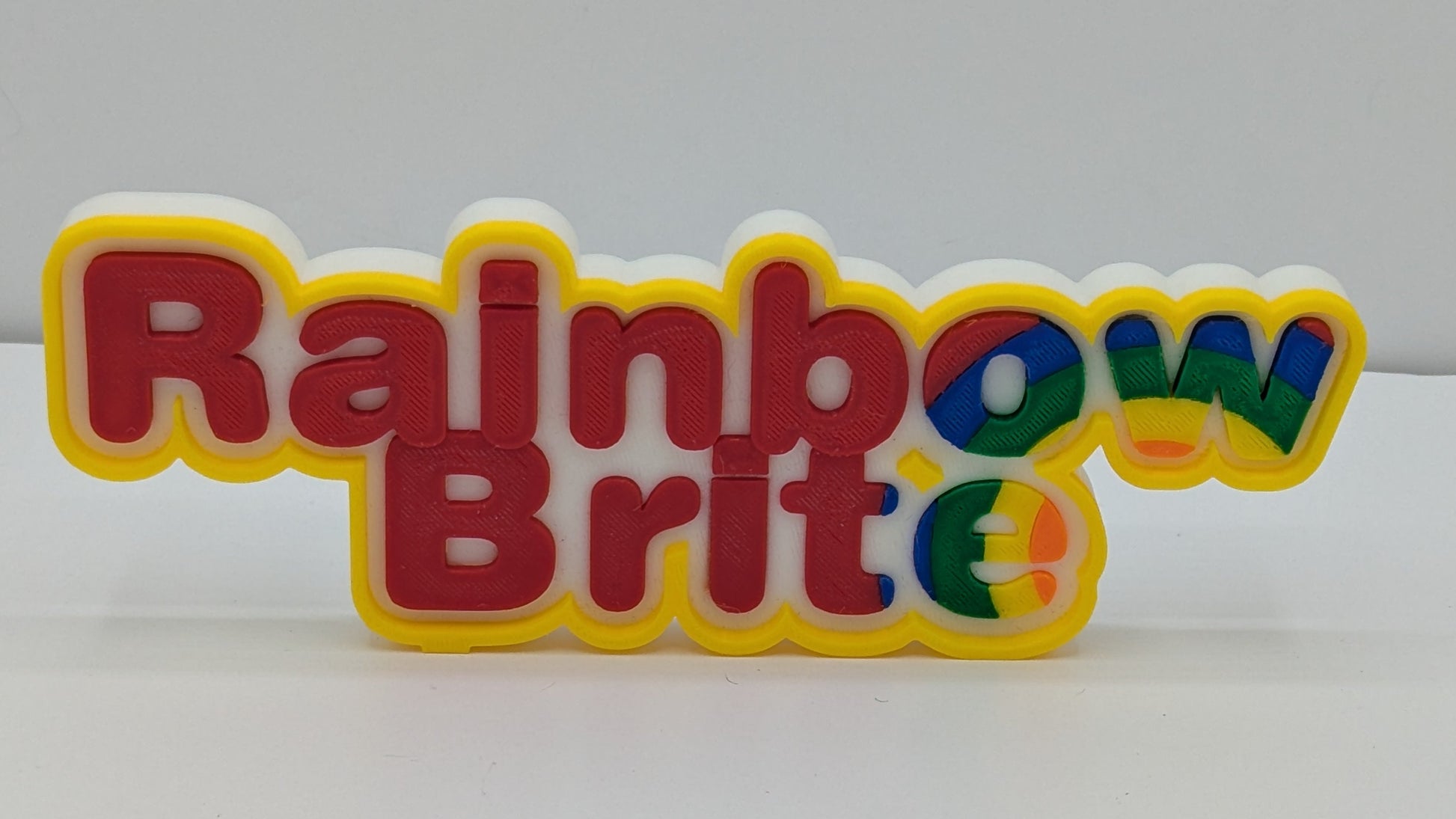 3d printed art piece with "rainbow Brite" in multicolour lettering. 