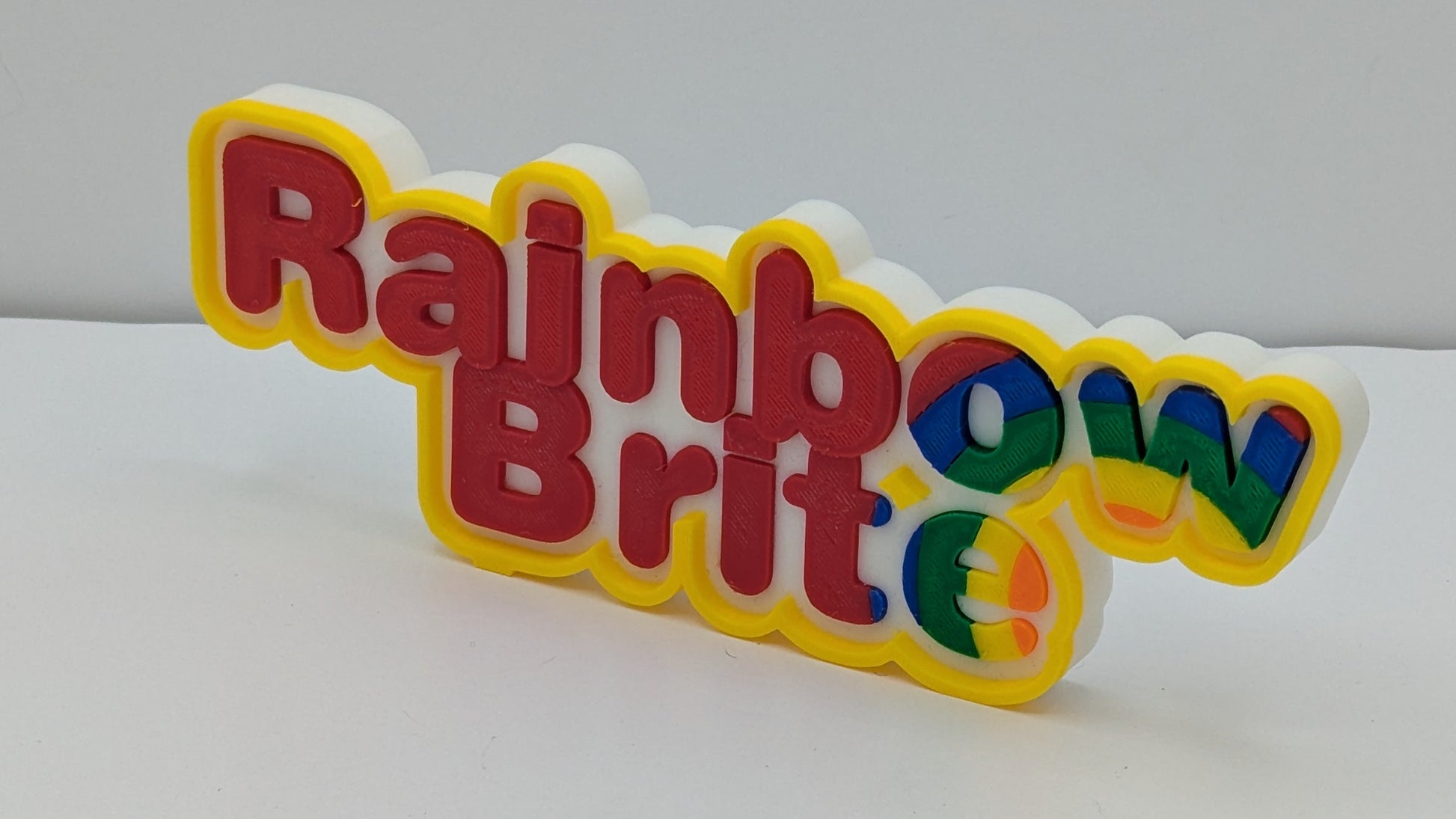 3d printed art piece with "rainbow Brite" in multicolour lettering. 