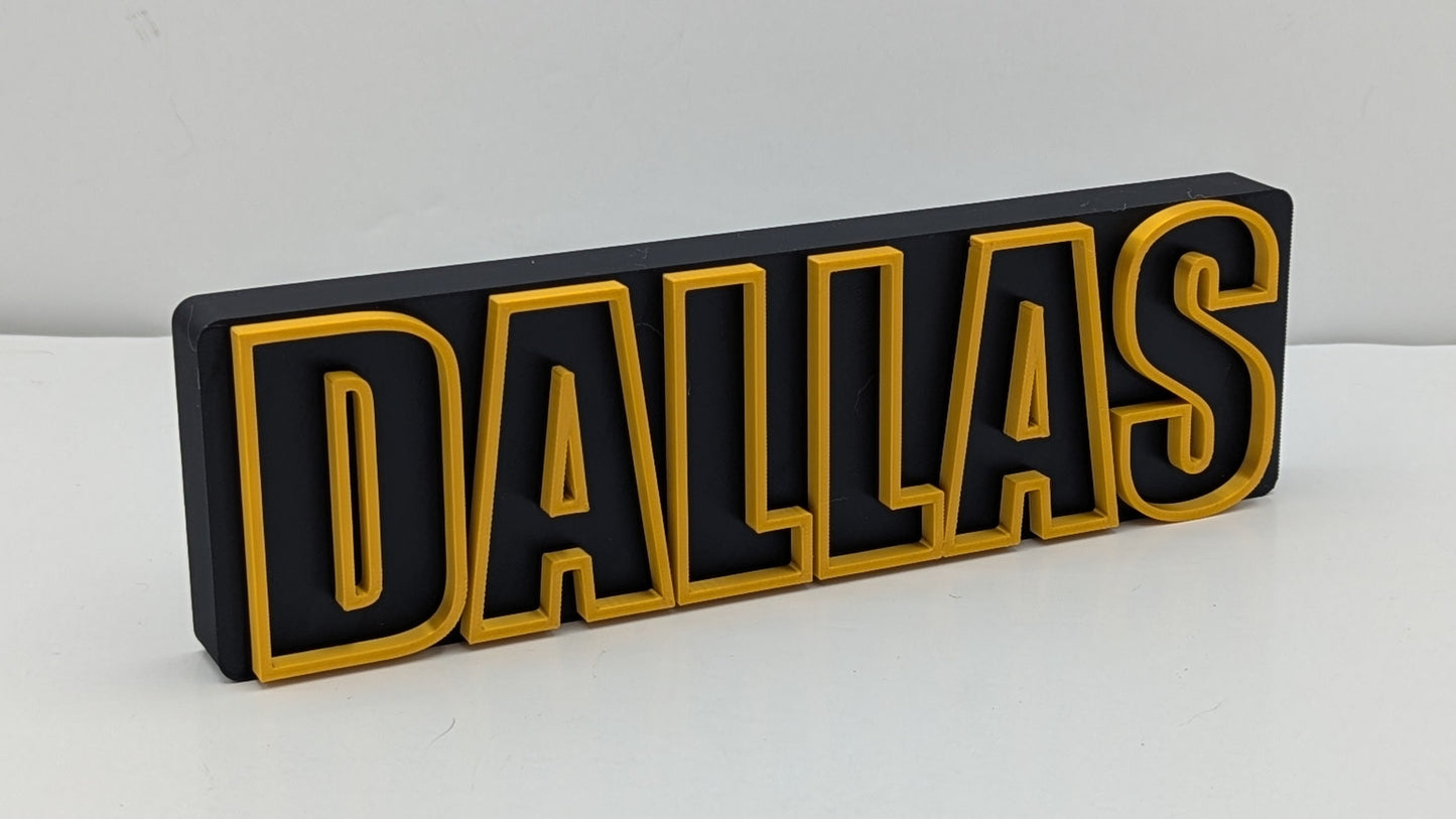 3D-printed 'DALLAS' letter block on a white background