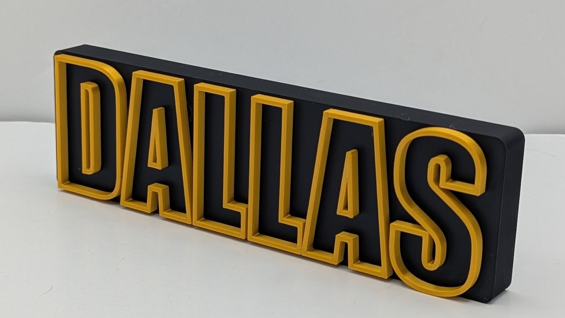 dallas in gold text on a black background