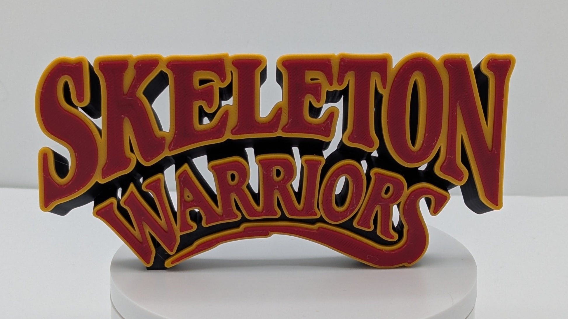 Decorative sign with 'Skeleton Warriors' text on a white base