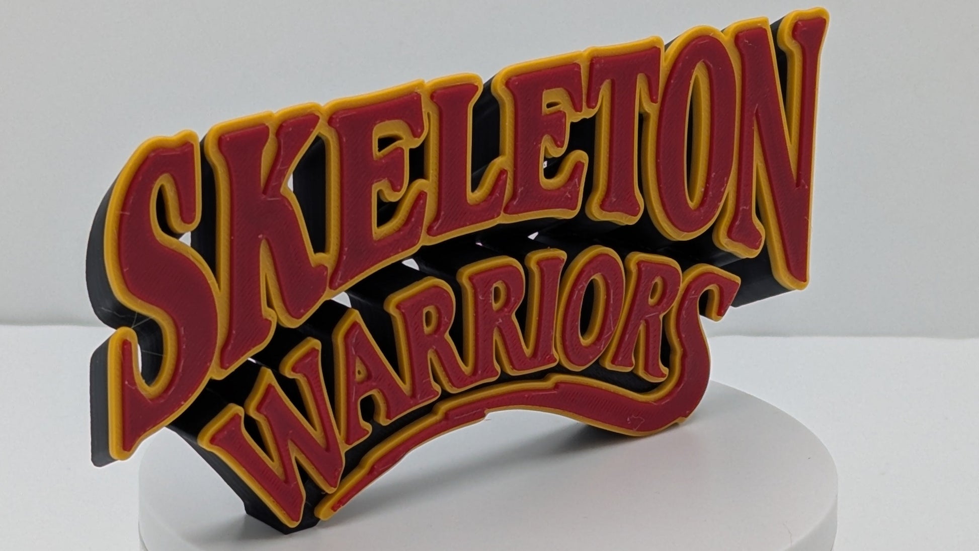 Decorative sign with 'Skeleton Warriors' text on a white base