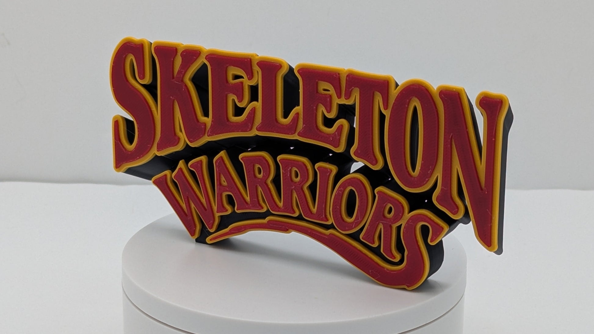 Decorative sign with 'Skeleton Warriors' text on a white base