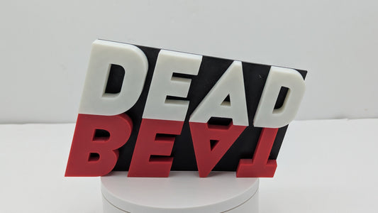 Decorative item with 'DEAD BEAT' text on a white background