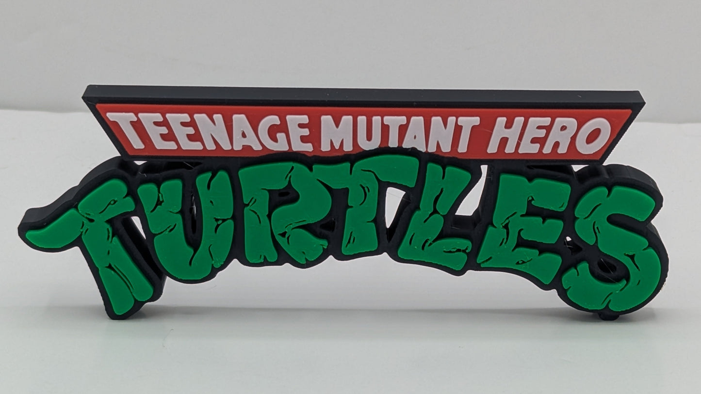 Decorative sign with 'TEENAGE MUTANT HERO TURTLES' text on a white background