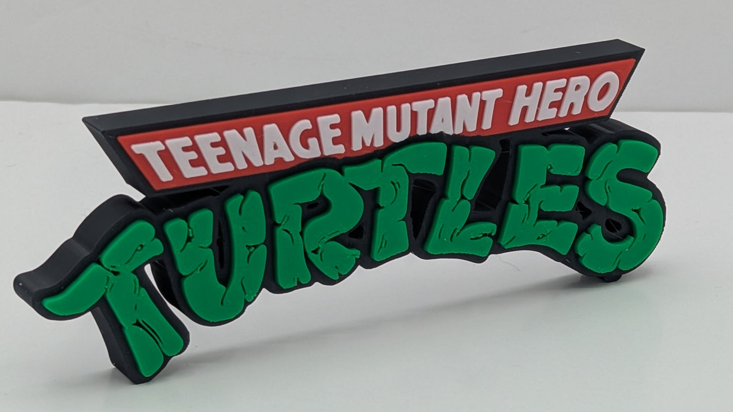 Decorative sign with 'Teenage Mutant Hero Turtles' text on a white background