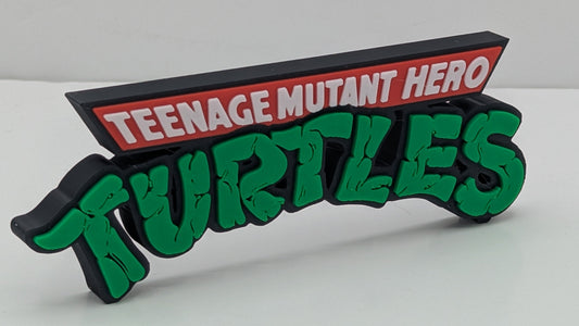 Decorative sign with 'Teenage Mutant Hero Turtles' text on a white background