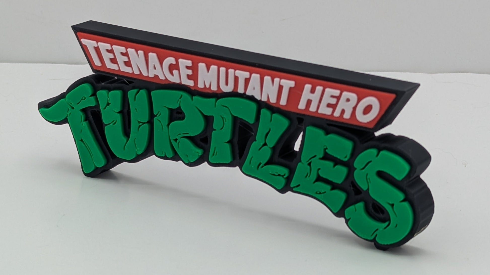 Decorative sign with 'Teenage Mutant Hero Turtles' text on a white background