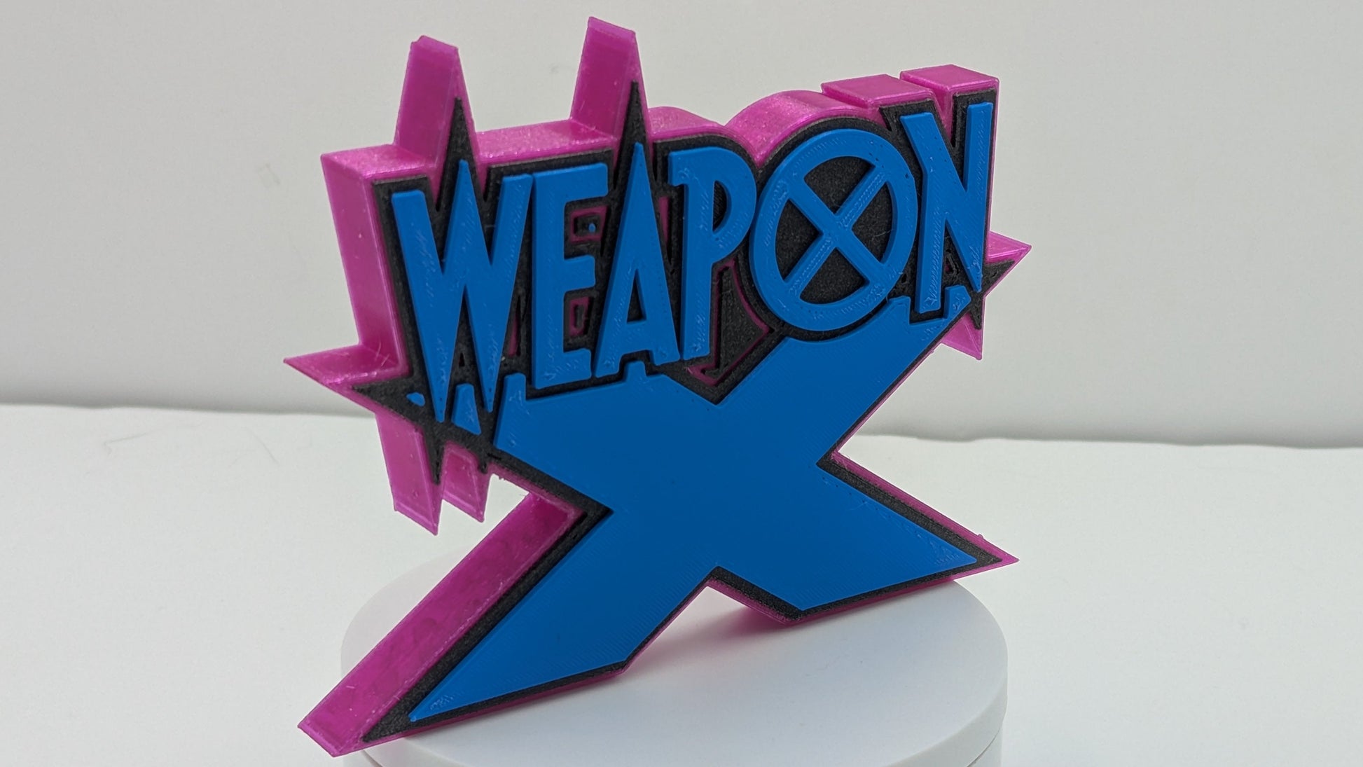 Decorative sign with 'Weapon X' text on a white background
