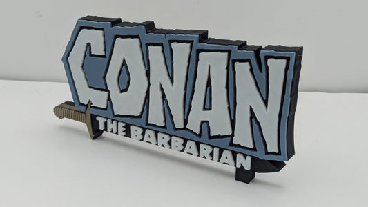 3D-printed 'Conan the Barbarian' logo with a sword on a white background