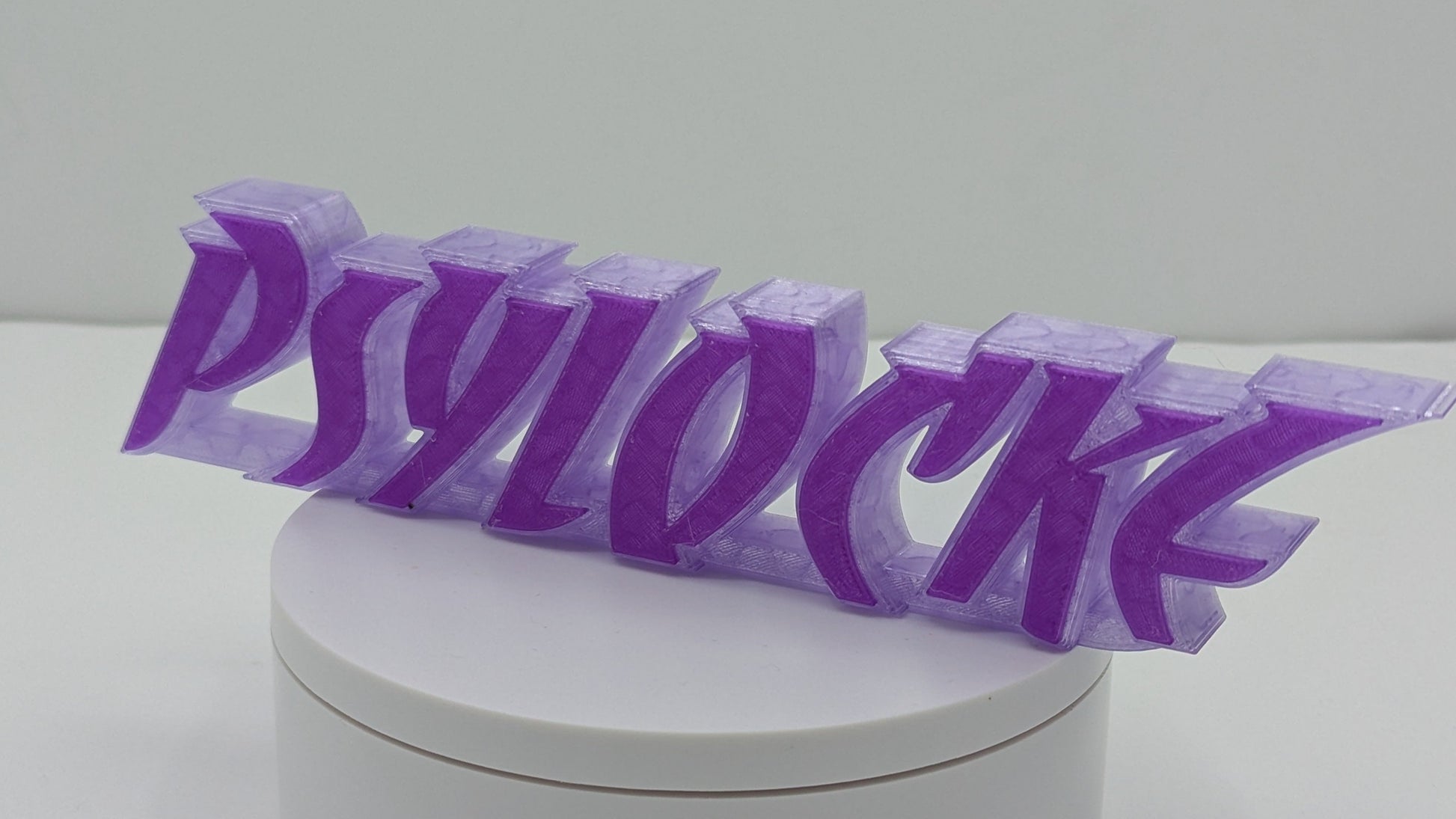 Purple 'PSYLOCKZ' lettering on a white cylindrical base against a light gray background