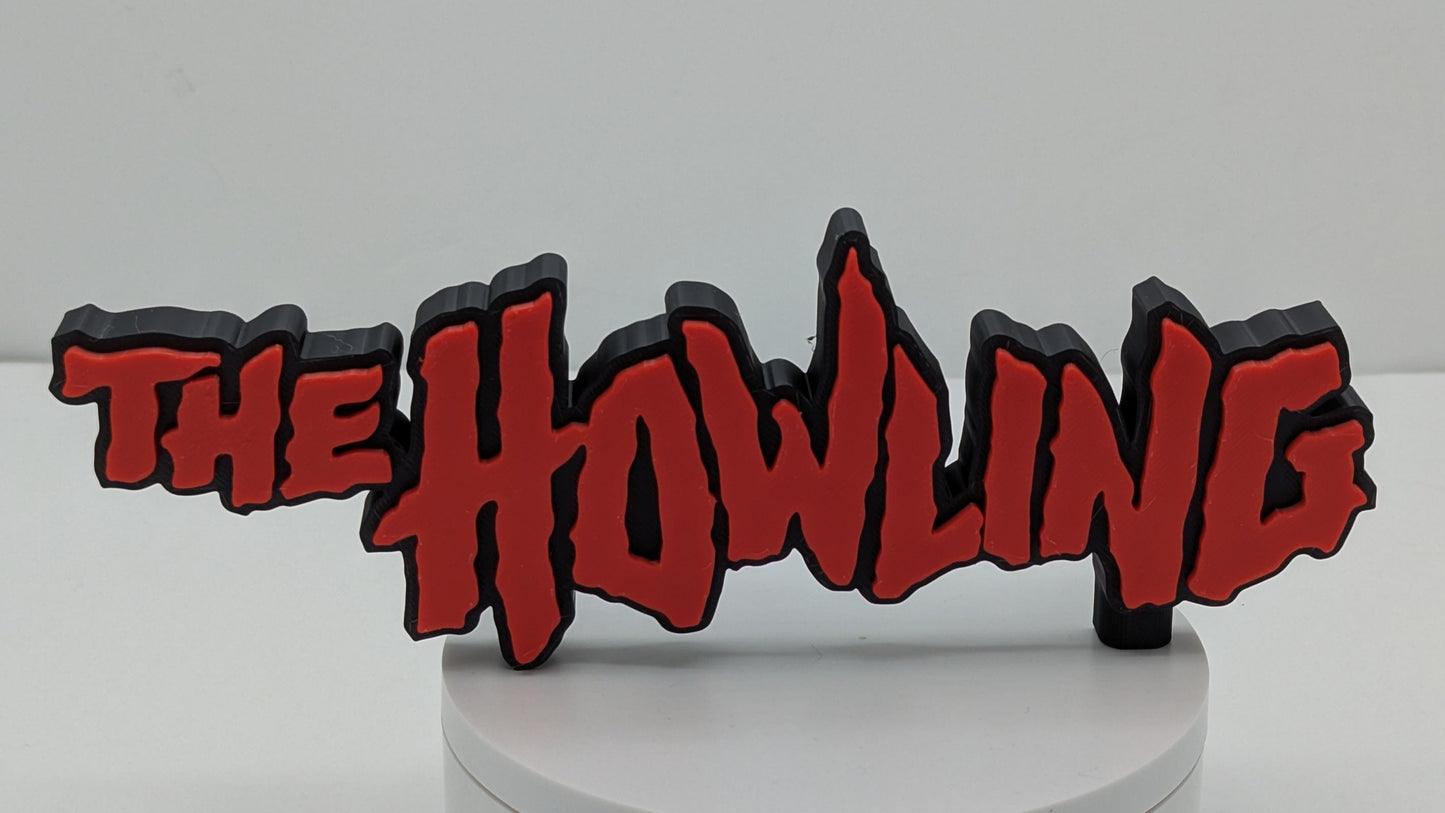 Decorative sign with 'The Howling' text on a white base against a gray background
