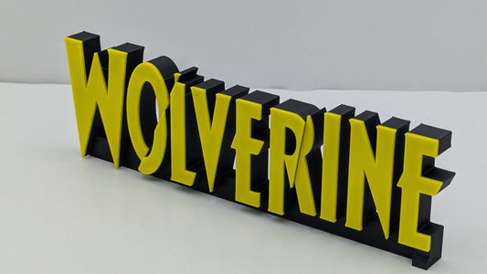 3D printed nameplate with 'WOLVERINE' in yellow on a black background