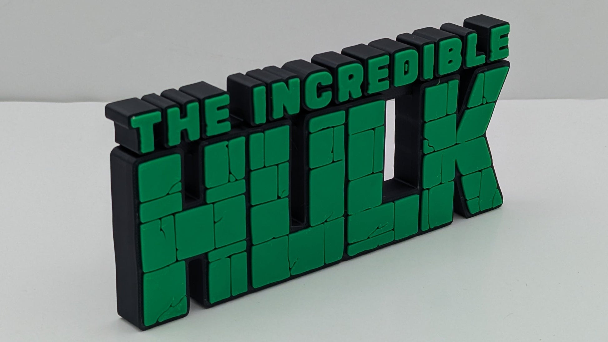 Green and black 'The Incredible Hulk' logo on a white background