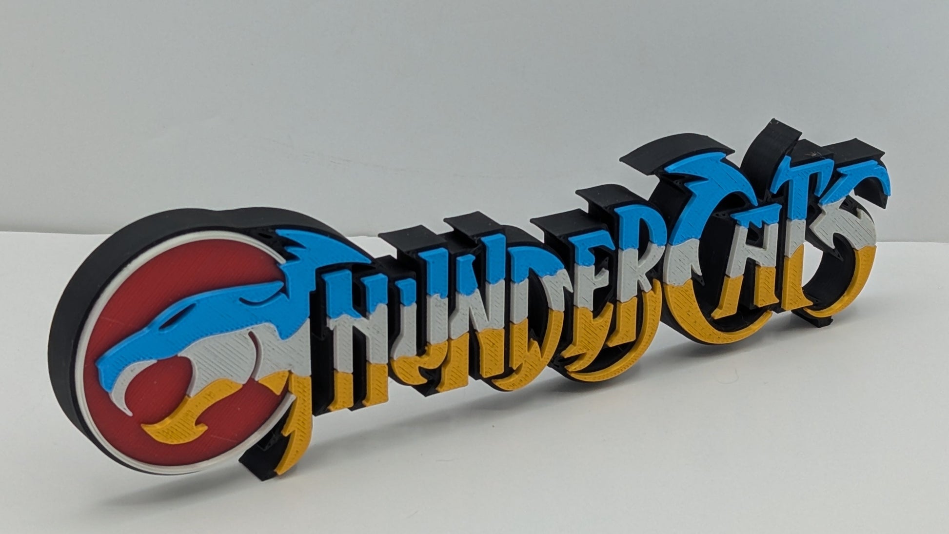 3D printed 'Thundercats' logo on a white background