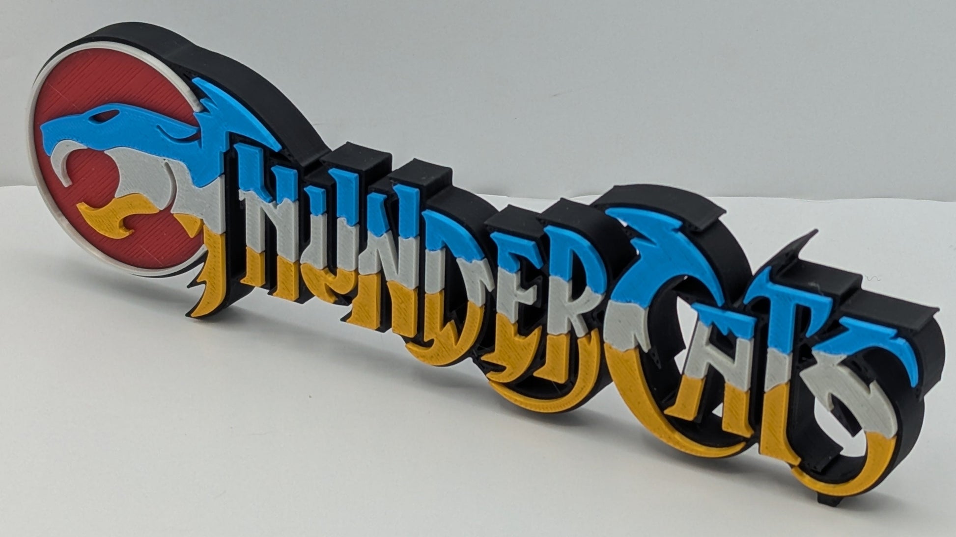 3D printed 'ThunderCats' logo on a white background