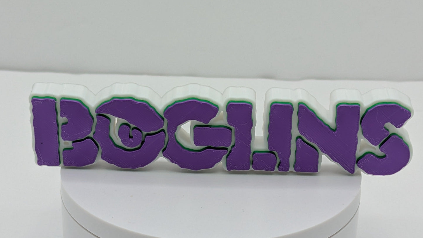 Round white box with 'BOGLINS' in purple and green on a white background