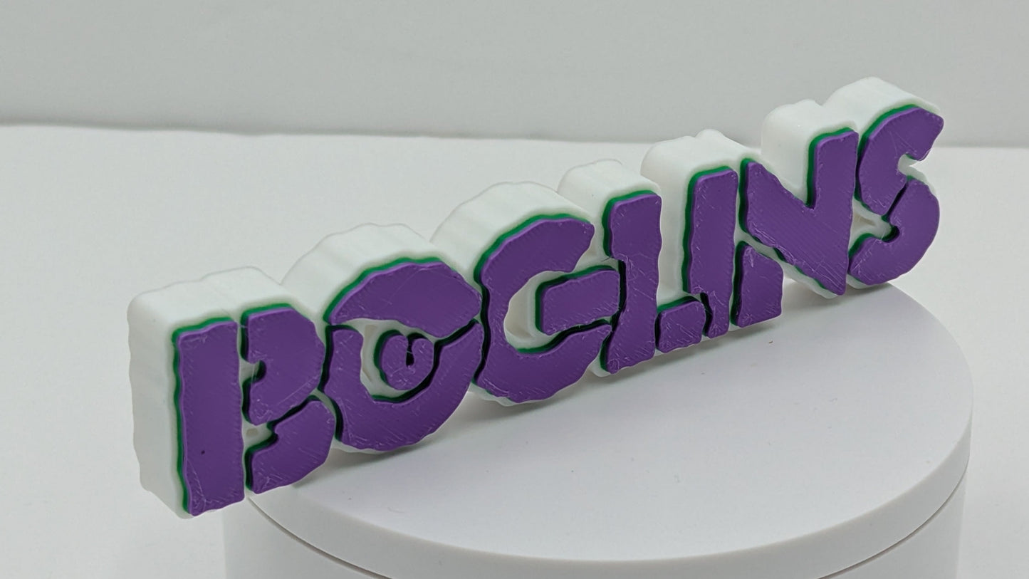 3D printed 'BOGLINS' logo on a white base with a gray background