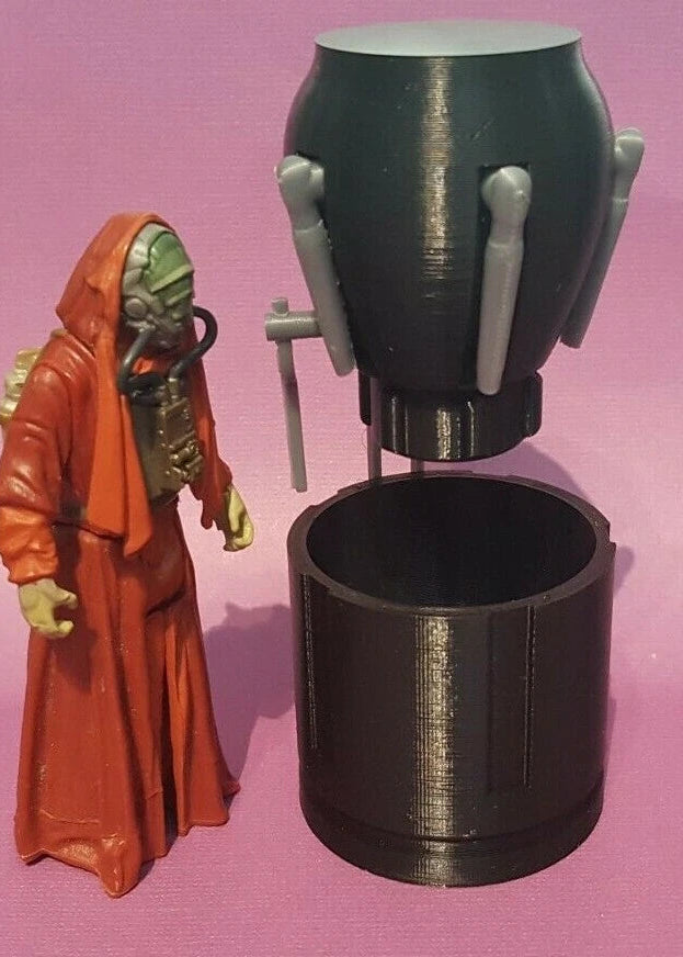 Figure in orange robe interacting with a black mechanical object on a pink background