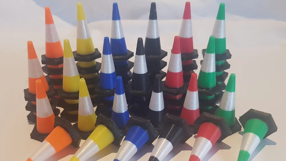 Colorful traffic cone-shaped bottle stoppers on a white background