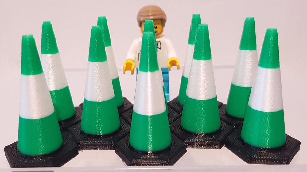 Green and white traffic cones with a small figure in the center on a plain background